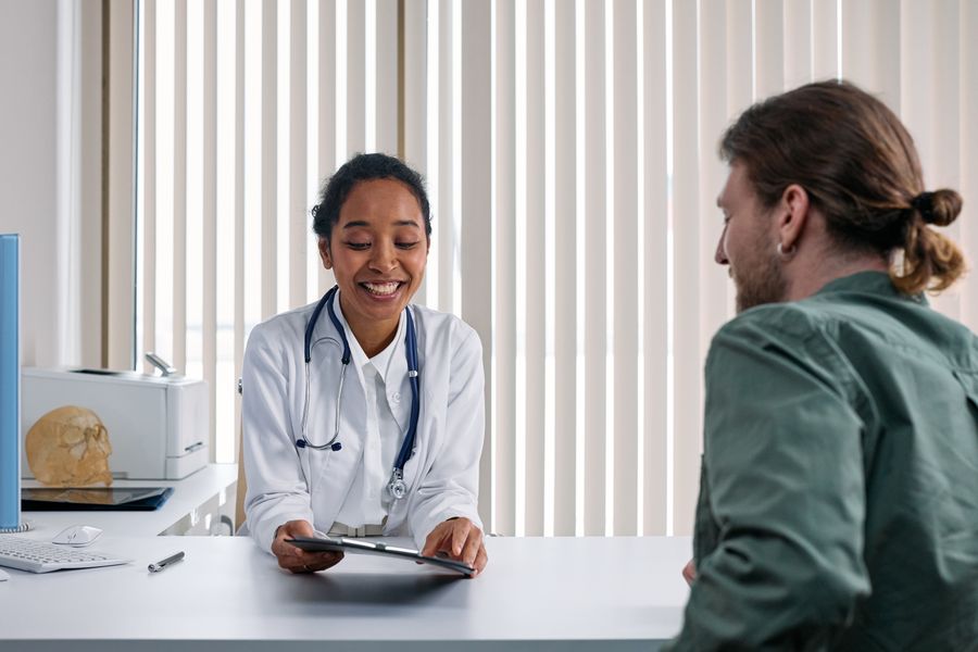 A physician talking with a patient across a desk